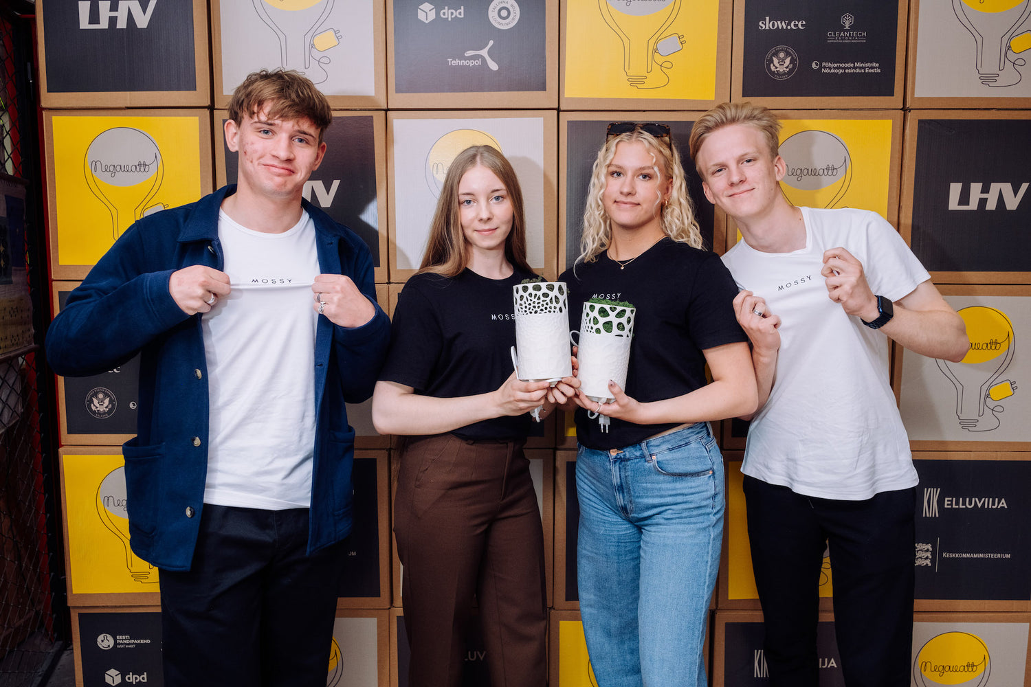 Mossy team at Negavatt holding Mossy air purifiers